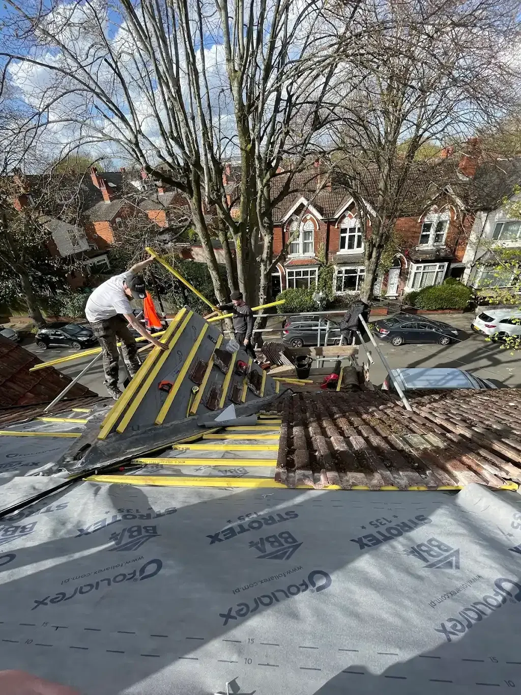 {client name} team re-roofing a suburban semi-detached property in {service area}